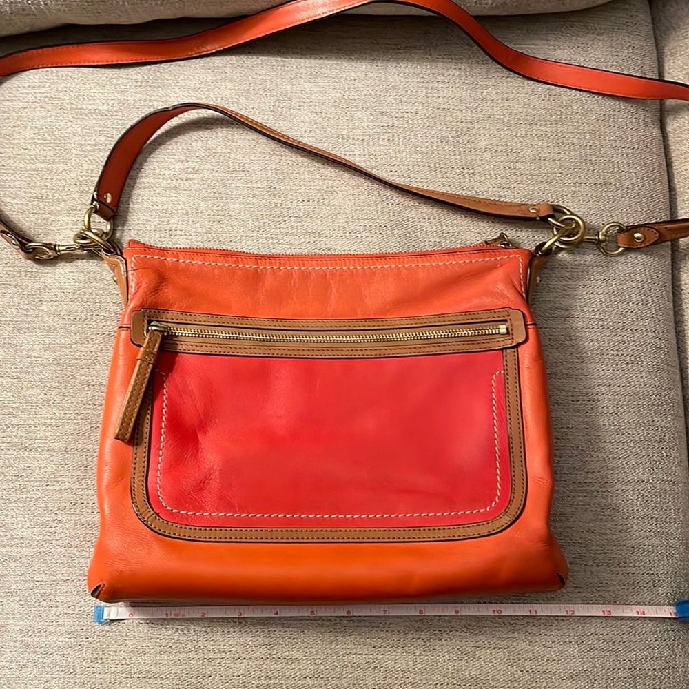 Coach cross body bag.  Coral, orange and tan. Good used condition.